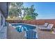 Backyard view of refreshing pool, lounge chairs and a wooden fence at 2301 Cass St, Sarasota, FL 34231