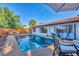 View of the pool in the backyard with various seating options at 2301 Cass St, Sarasota, FL 34231
