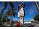 A tall sign for a seafood restaurant with palm trees in the background at 2301 Cass St, Sarasota, FL 34231