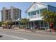 Lively street view with shops, outdoor seating, and beachgoers enjoying the coastal atmosphere at 2301 Cass St, Sarasota, FL 34231