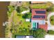 Overhead view of property with in-ground pool, solar panels, boat dock and outdoor seating area at 2410 Tanglewood Dr, Sarasota, FL 34239