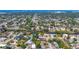 Aerial neighborhood view with trees, and houses with solar panels, nestled in a beautiful community setting at 2410 Tanglewood Dr, Sarasota, FL 34239