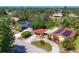 Aerial neighborhood view featuring well-maintained homes, lush landscaping, and convenient circular driveways at 2410 Tanglewood Dr, Sarasota, FL 34239