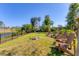 Scenic backyard with Adirondack chairs, firepit, waterfront views, and lush landscaping, creating a relaxing retreat at 2410 Tanglewood Dr, Sarasota, FL 34239