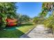 Expansive backyard with colorful kayaks stored safely, perfect for outdoor enthusiasts and water adventures at 2410 Tanglewood Dr, Sarasota, FL 34239