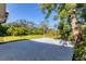 Spacious backyard with a concrete slab, grassy area, and lush landscaping, offering privacy and tranquility at 2410 Tanglewood Dr, Sarasota, FL 34239