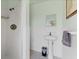 Bathroom featuring a standing shower, a pedestal sink, and tiled walls at 2410 Tanglewood Dr, Sarasota, FL 34239