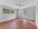 Spacious bedroom with neutral walls, a ceiling fan, and three windows at 2410 Tanglewood Dr, Sarasota, FL 34239