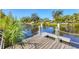 Dock by water with rope accents, inviting residents to enjoy waterfront activities and scenic views at 2410 Tanglewood Dr, Sarasota, FL 34239