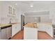 Kitchen with stainless steel appliances, central island, and white cabinetry at 2410 Tanglewood Dr, Sarasota, FL 34239