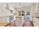 Kitchen with a central island, stainless appliances, and access to the outdoor area at 2410 Tanglewood Dr, Sarasota, FL 34239