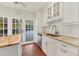 Kitchen featuring granite countertops, stainless steel appliances, and white cabinets at 2410 Tanglewood Dr, Sarasota, FL 34239