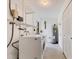 Laundry room equipped with washer, dryer, storage shelves, and water heater at 2410 Tanglewood Dr, Sarasota, FL 34239