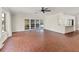 Spacious living room with tile flooring and access to the kitchen and patio at 2410 Tanglewood Dr, Sarasota, FL 34239