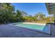 Sun-drenched pool offers a refreshing escape, complete with a fenced surround and beautiful landscaping at 2410 Tanglewood Dr, Sarasota, FL 34239