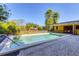 Inviting pool with patio, perfect for summer relaxation; the house is yellow and inviting at 2410 Tanglewood Dr, Sarasota, FL 34239