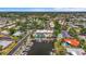 Beautiful aerial view of community featuring boat docks, a swimming pool, clubhouse, and lush landscaping at 2531 Riverbluff Pkwy # V181, Sarasota, FL 34231