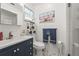 Bathroom featuring vanity, toilet, and shower with white tile, with nautical decor at 2531 Riverbluff Pkwy # V181, Sarasota, FL 34231