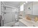 Bathroom showcasing a tub with sliding door, a marble countertop sink, and decorative fish accents at 2531 Riverbluff Pkwy # V181, Sarasota, FL 34231