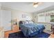 Serene bedroom featuring a plush bed, nautical-themed decor, and a window with blinds at 2531 Riverbluff Pkwy # V181, Sarasota, FL 34231