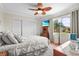 Tranquil bedroom with a large window, wood floors, comfortable bed, and modern decor at 2531 Riverbluff Pkwy # V181, Sarasota, FL 34231