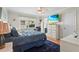 Relaxing bedroom with blue bedding, a mounted TV, and natural light from the window at 2531 Riverbluff Pkwy # V181, Sarasota, FL 34231