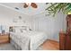 Cozy bedroom with closet doors, a comfortable bed, hardwood floors, and neutral decor at 2531 Riverbluff Pkwy # V181, Sarasota, FL 34231