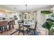 Charming dining area with a glass table, seating for four, and modern light fixture at 2531 Riverbluff Pkwy # V181, Sarasota, FL 34231