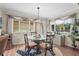 Bright dining area with glass table and large windows providing ample natural light and stylish decor at 2531 Riverbluff Pkwy # V181, Sarasota, FL 34231