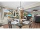 Cozy dining area open to living room featuring a glass table set for four and casual decor at 2531 Riverbluff Pkwy # V181, Sarasota, FL 34231
