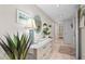 Hallway featuring console table with decorative mirror and coastal decor at 2531 Riverbluff Pkwy # V181, Sarasota, FL 34231