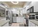 Modern kitchen with white cabinets, stainless steel appliances and ample counter space at 2531 Riverbluff Pkwy # V181, Sarasota, FL 34231