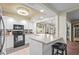 Bright kitchen featuring white cabinetry, breakfast bar and modern appliances at 2531 Riverbluff Pkwy # V181, Sarasota, FL 34231
