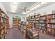 Charming library featuring ceiling fan, carpet, and abundant bookshelves at 2531 Riverbluff Pkwy # V181, Sarasota, FL 34231
