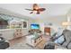 Cozy living room with a comfortable seating arrangement, wood flooring, and a window for natural light at 2531 Riverbluff Pkwy # V181, Sarasota, FL 34231
