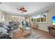 Comfortable living room featuring a ceiling fan, a plush sofa, and beach themed decor at 2531 Riverbluff Pkwy # V181, Sarasota, FL 34231