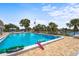 Community pool featuring clear blue water, surrounding lounge chairs, palm trees, and inviting atmosphere at 2531 Riverbluff Pkwy # V181, Sarasota, FL 34231