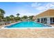 Community pool featuring a spacious pool deck and covered seating area at 2531 Riverbluff Pkwy # V181, Sarasota, FL 34231
