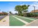 Shuffleboard court surrounded by mature trees and beautiful blue skies at 2531 Riverbluff Pkwy # V181, Sarasota, FL 34231
