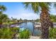 Picturesque water view showing boat docks and tropical landscaping at 2531 Riverbluff Pkwy # V181, Sarasota, FL 34231