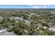 Expansive aerial view showcasing a residential area with mature trees and pool at 2535 Floyd St, Sarasota, FL 34239