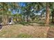 Lush backyard with a grass lawn, mature landscaping and a privacy fence at 2535 Floyd St, Sarasota, FL 34239