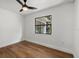 Bedroom with hardwood floors, crisp white paint, and a large double hung window at 2535 Floyd St, Sarasota, FL 34239