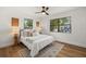 Stylishly furnished bedroom features wood floors, neutral decor, and ample natural light at 2535 Floyd St, Sarasota, FL 34239