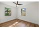 Bedroom with hardwood floors, crisp white paint, and a large double hung window at 2535 Floyd St, Sarasota, FL 34239