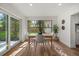 Bright dining room with modern table set, a large window with backyard views, and hardwood flooring throughout at 2535 Floyd St, Sarasota, FL 34239