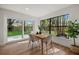 Cozy dining area featuring hardwood floors, an airy atmosphere from natural light, and serene backyard views at 2535 Floyd St, Sarasota, FL 34239