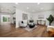 Bright living room featuring modern decor, hard wood floors, white walls, with a glimpse into the kitchen at 2535 Floyd St, Sarasota, FL 34239