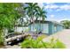 Charming outdoor space featuring a fish pond with a small wooden bridge and lots of vegetation at 2598 Wood St, Sarasota, FL 34237
