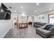 Bright living room featuring modern gray sofa, wood floors, recessed lighting and beach-themed decor at 2598 Wood St, Sarasota, FL 34237